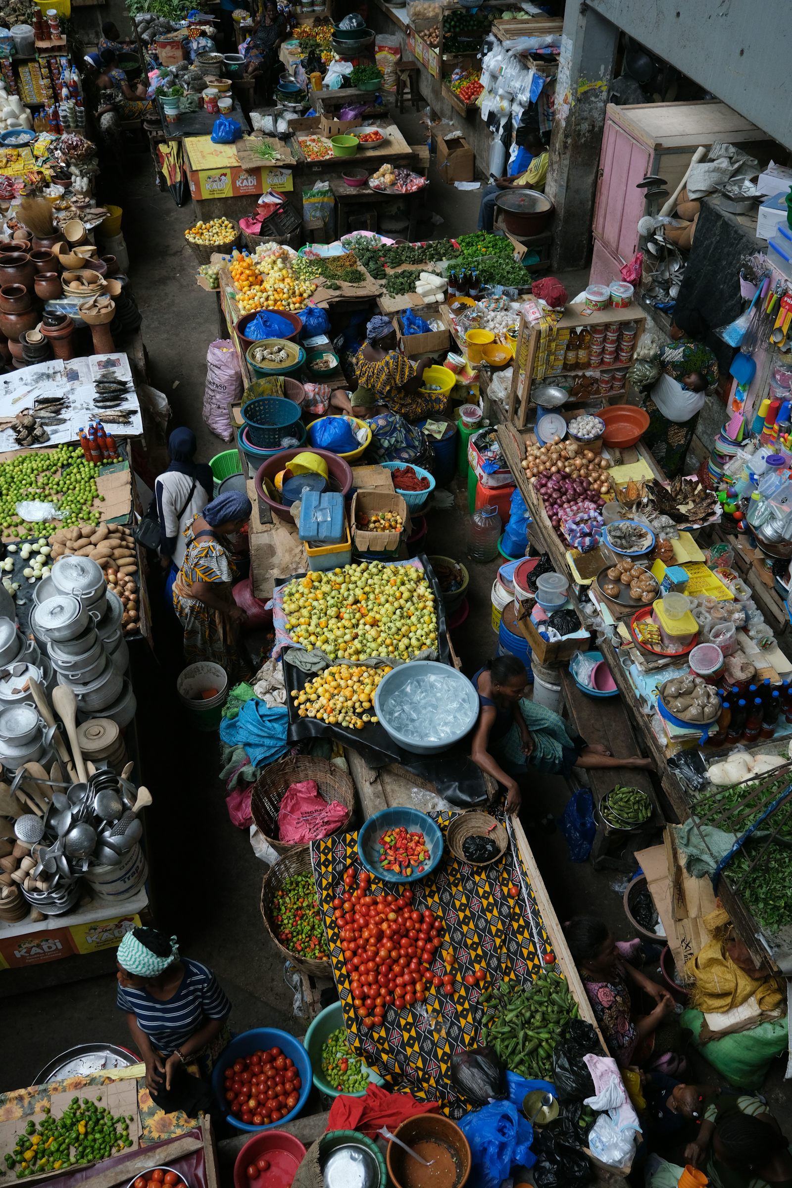 Aerial view of a crowded open-air market with colourful stalls